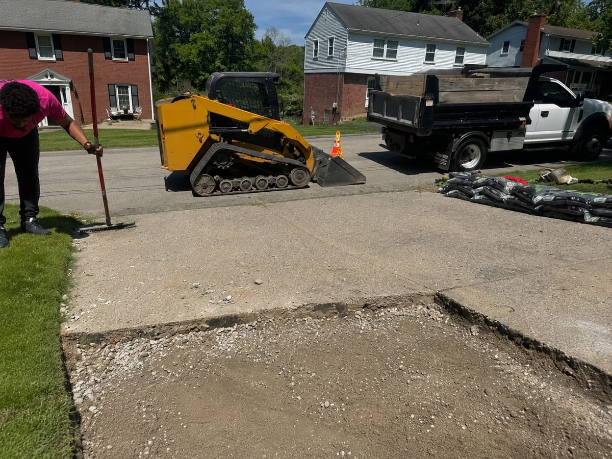Pittsburgh concrete repair contractors clearing a driveway cut-out before the pour