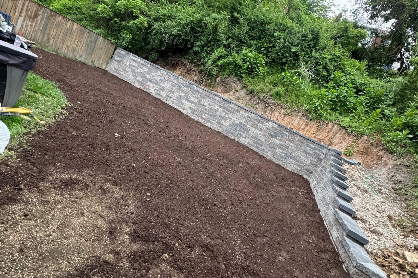 Segmental block retaining wall and regraded hillside on a Pittsburgh property