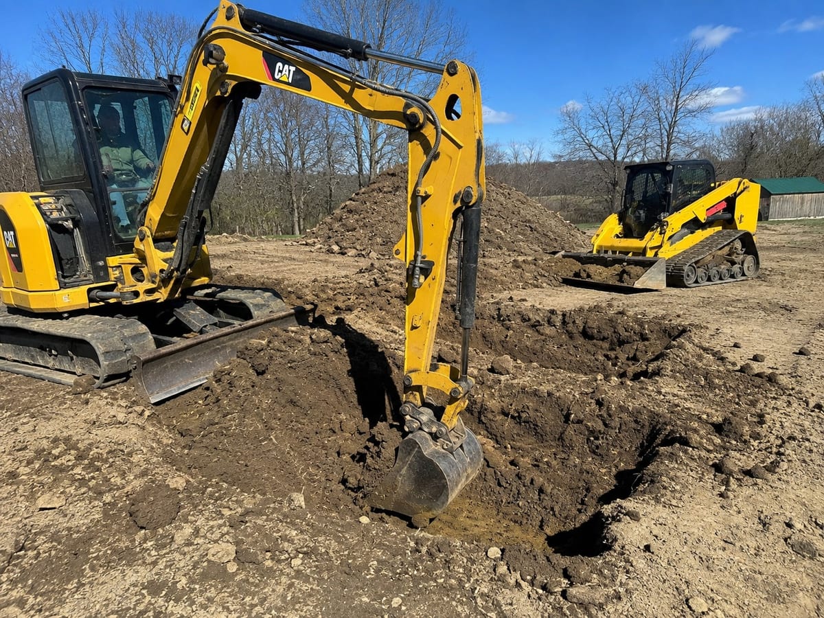 Mini excavator digging a trench on a Pittsburgh excavation project