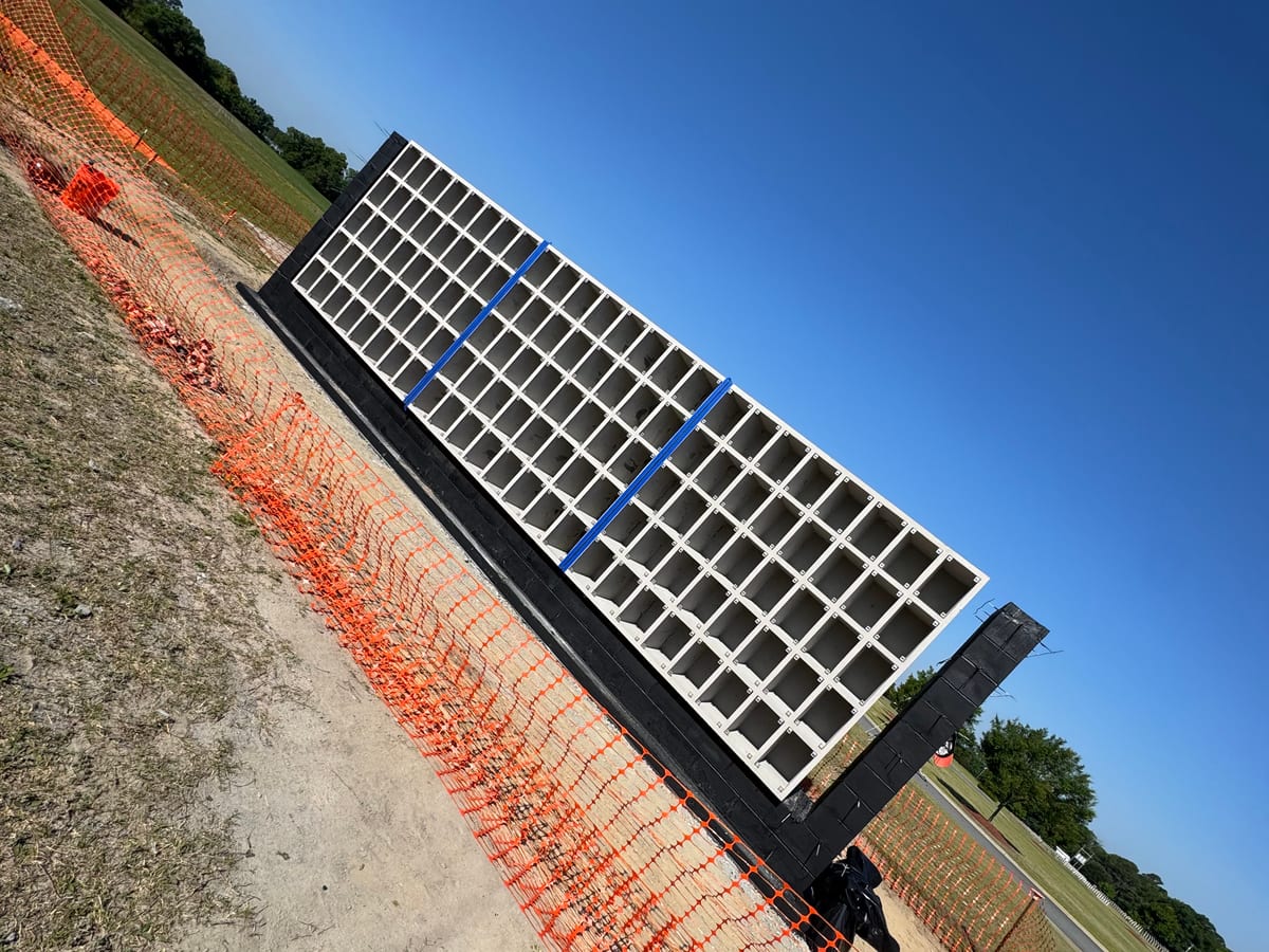 Precast concrete open-grid niche unit set on its finished foundation base