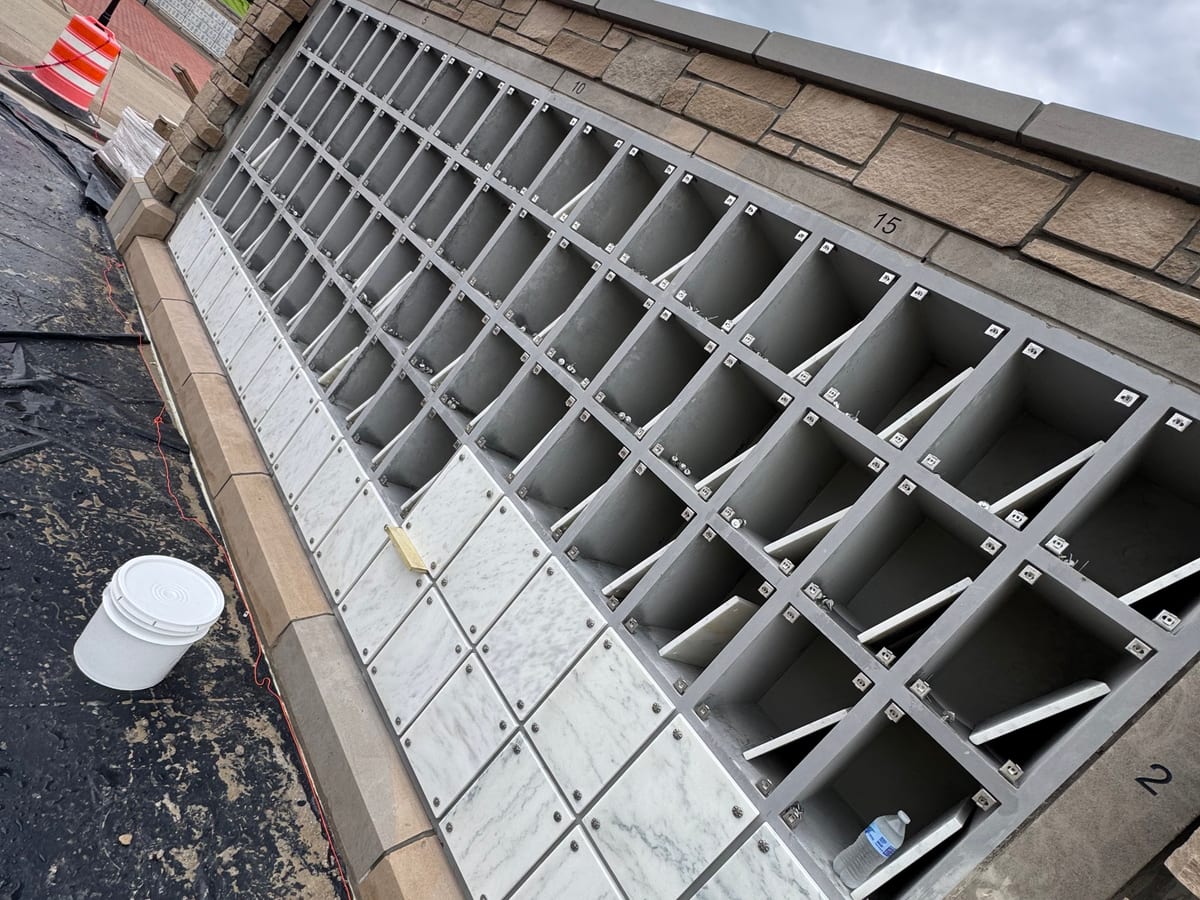 Open-grid precast concrete cells with front panels being fitted