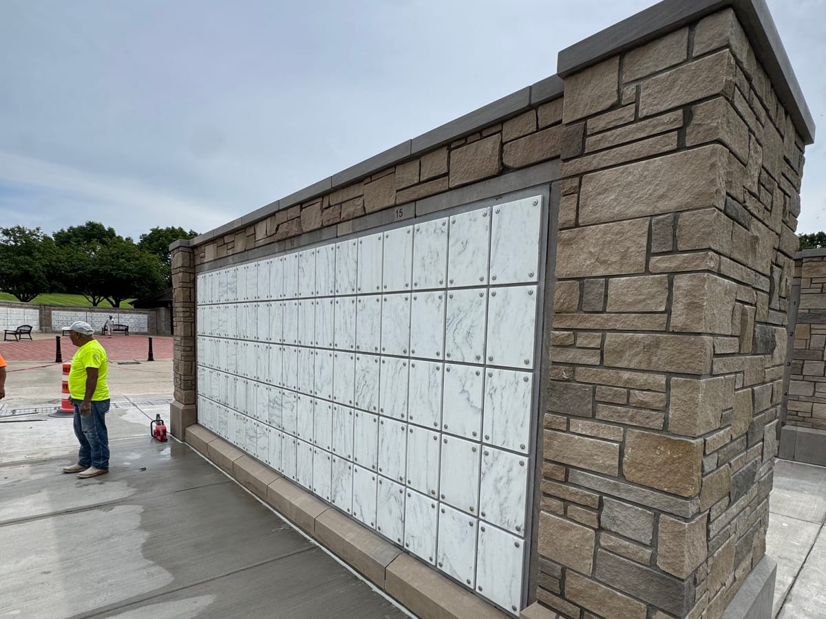Completed precast concrete wall with stone cladding, cap and fitted marble front panels